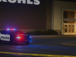 Hanford Police patrol car at night with flashing lights outside Kohls sto 20250427 154704 0000