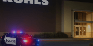 Hanford Police patrol car at night with flashing lights outside Kohls sto 20250427 154704 0000