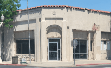 Interior of the condemned building at 103 North Dowdy Street in downtown Hanford California showing severe structural damage exposed framing debris and signs of neglect highlighting public s