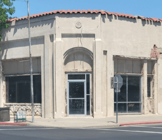 Interior of the condemned building at 103 North Dowdy Street in downtown Hanford California showing severe structural damage exposed framing debris and signs of neglect highlighting public s